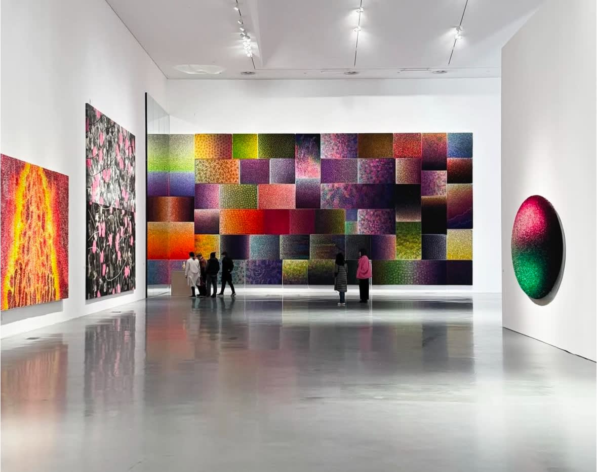 Viewers immersed in Zhuang Hong Yi's 'Kaleidoscope' exhibit, marveling at vibrant, color-shifting, nature-inspired installations.