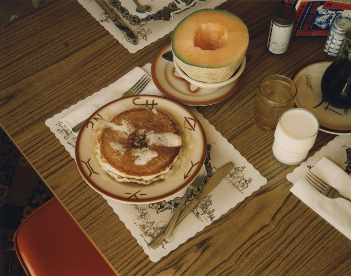 close-up color photograph of half cantaloupe and stack of pancakes at diner in 1970s by Stephen Shore