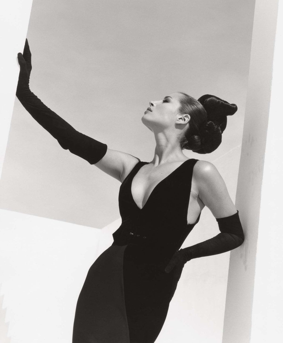 Christy Turlington in Valentino gown and gloves, posing in geometric doorway, by Herb Ritts