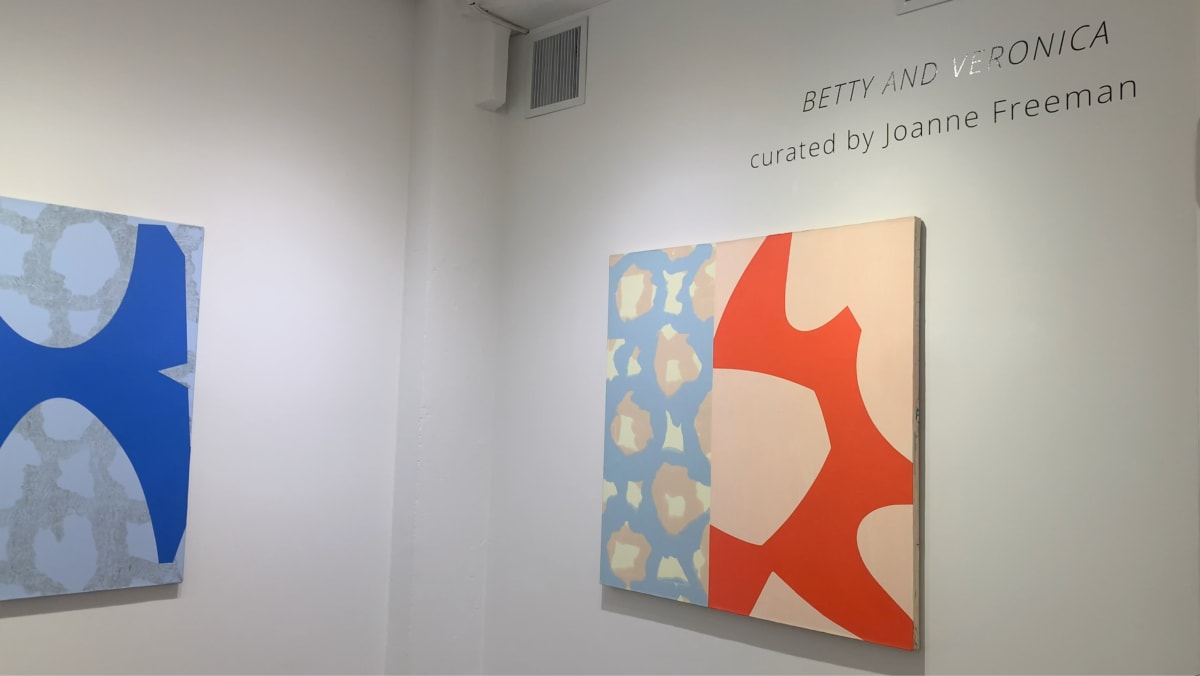 Two blue and red abstract paintings on gallery wall from exhibition Betty and Veronica.