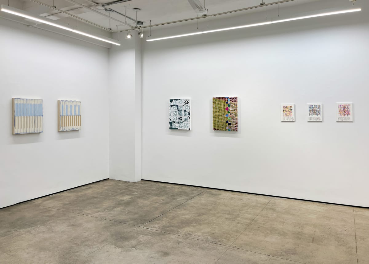 Artworks hanging in a gallery.
