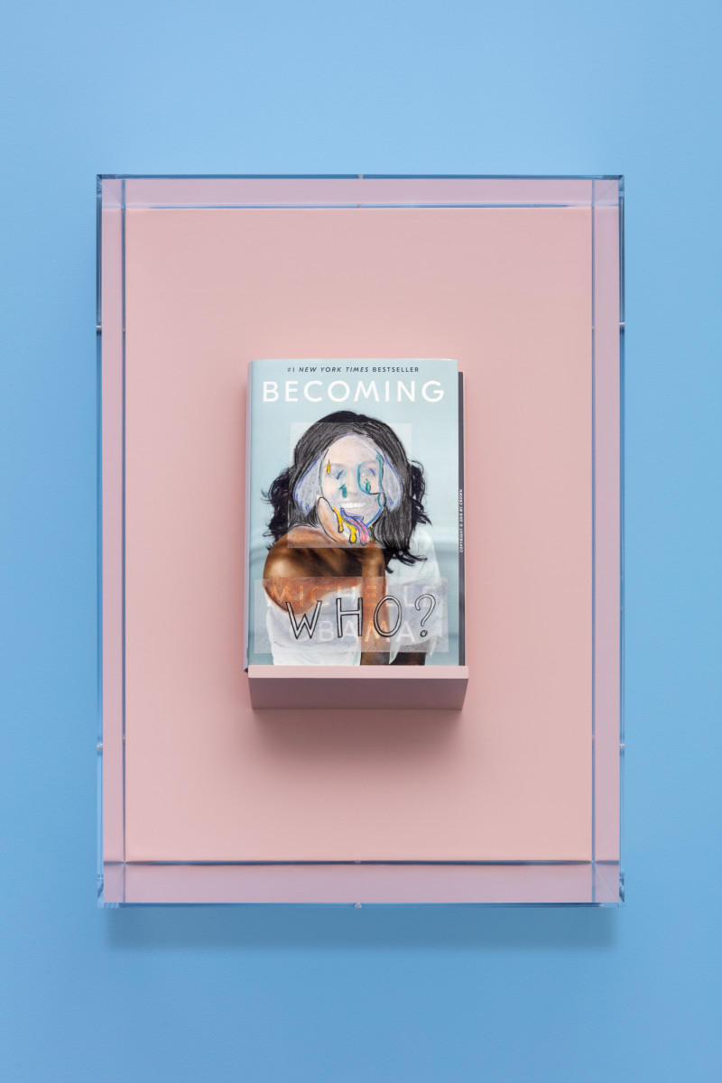 Simon Fujiwara Becoming Who? (A New York Times Bestseller), 2021 Book, artificial leather in Plexiglas vitrine 28,2 x 16,4 x 3,4 cm (11 1/8 x 6 1/2 x 1 3/8 in) (book) 52,2 x 37,6 x 26,4 cm (20 1/2 x 14 3/4 x 10 3/8 in) (vitrine) Edition of 10 plus 2 artist's proofs