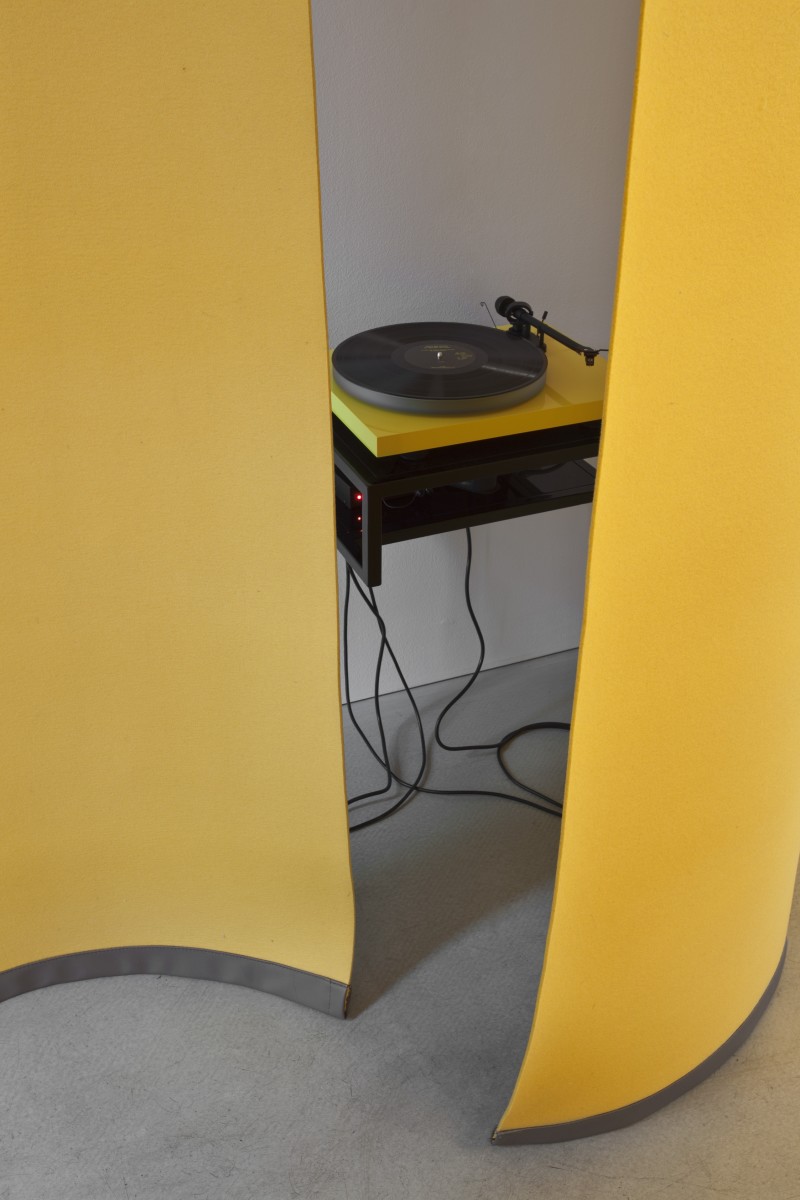 Detail: Angela Bulloch, Yellow Music Station – Extra Large, 2012, six yellow felt curtains, yellow Alvar Aalto Stool, wall mounted table, sound system, wall mount, 180 cm width each, 6 part (curtain). Photo © Andrea Rossetti