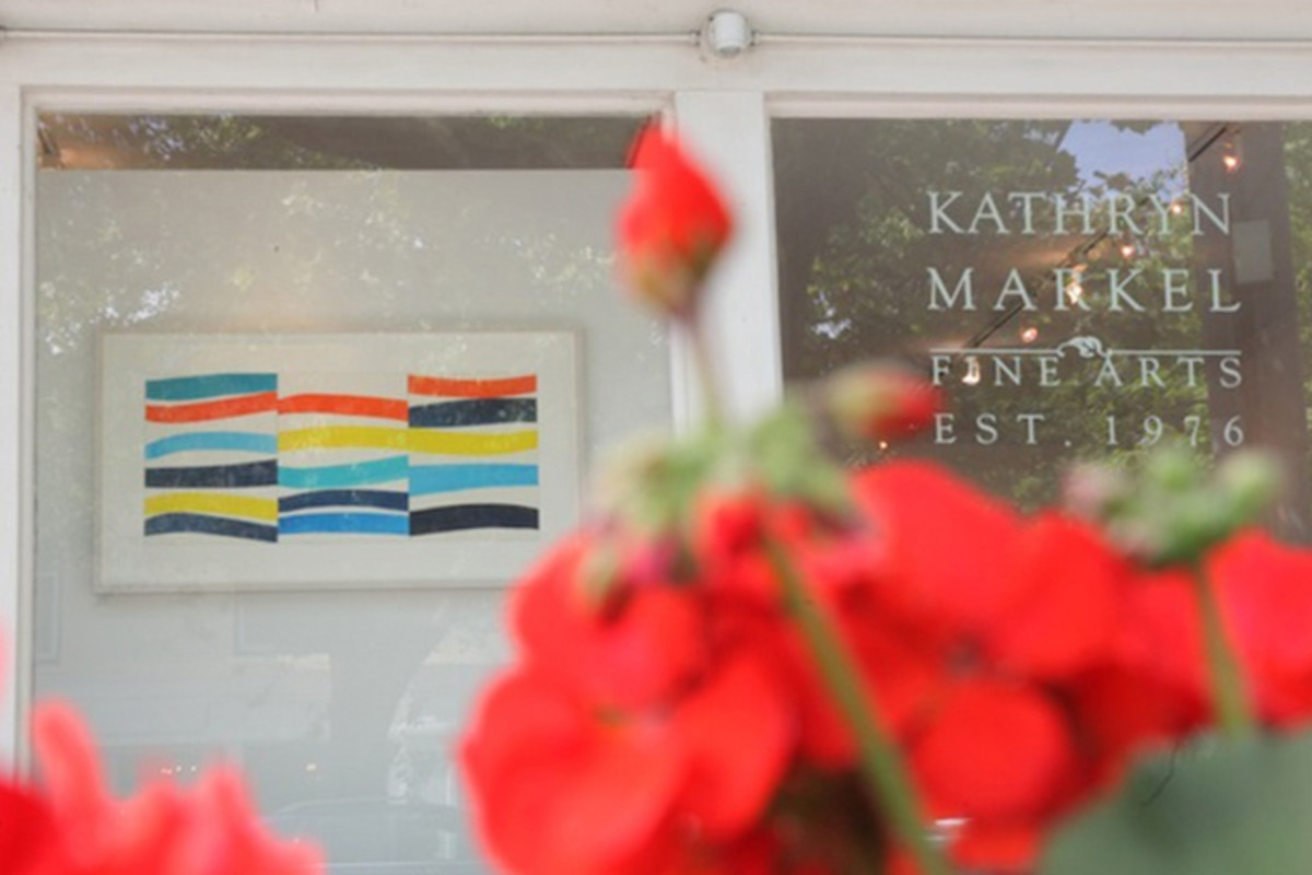 A photograph of Kathryn Markel Fine Arts' Bridgehampton location with a watercolor painting by Kim Uchiyama on display. It was shot behind red roses.