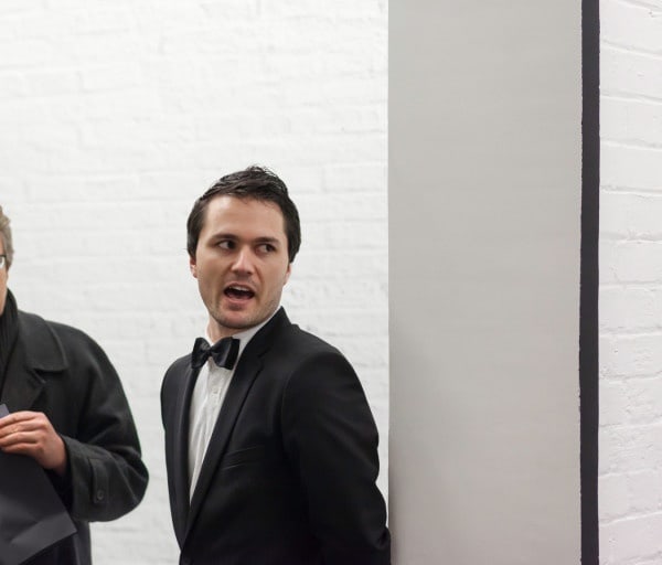 photo of person in tuxedo talking to someone off frame