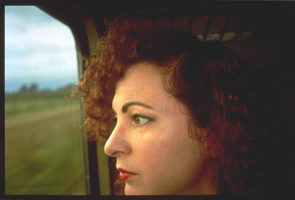 portrait of person looking out train window
