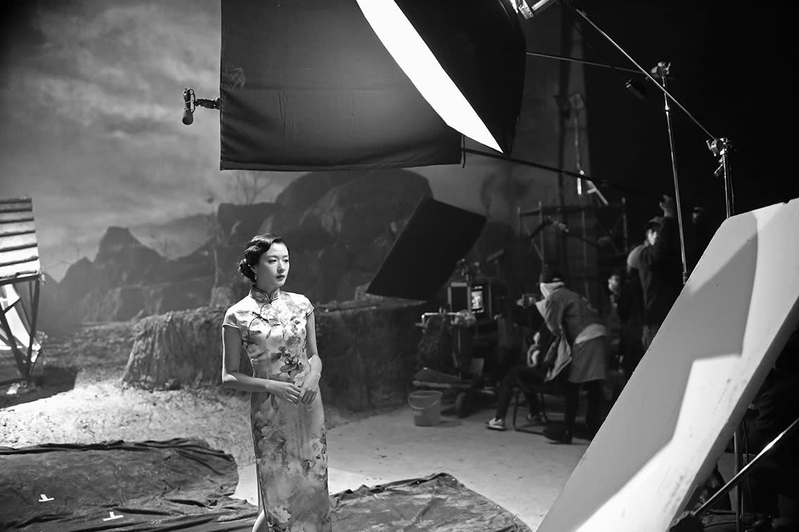 An image containing a woman on the set of a film by Yang Fudong