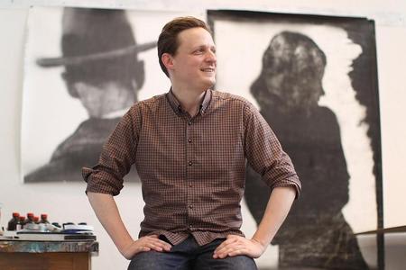 Artist Matt Saunders in front of two of his pieces.