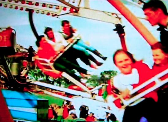 Image of four people on an amusement park ride.