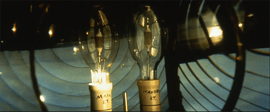 two light bulbs in the dark; a still from Dean's "Disappearance at Sea"