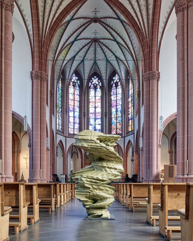 An image containing a sculpture by Tony Cragg, installed inside of a church.