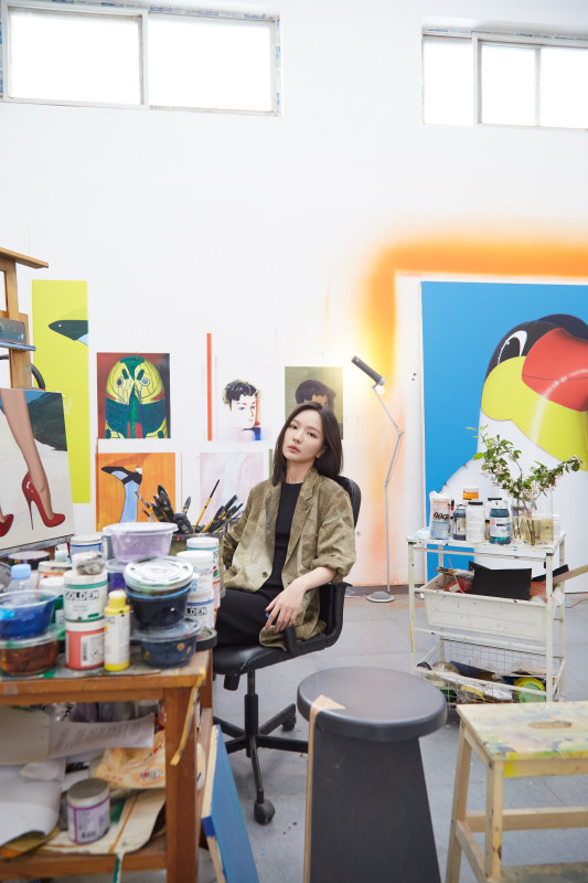 a woman standing in an art studio