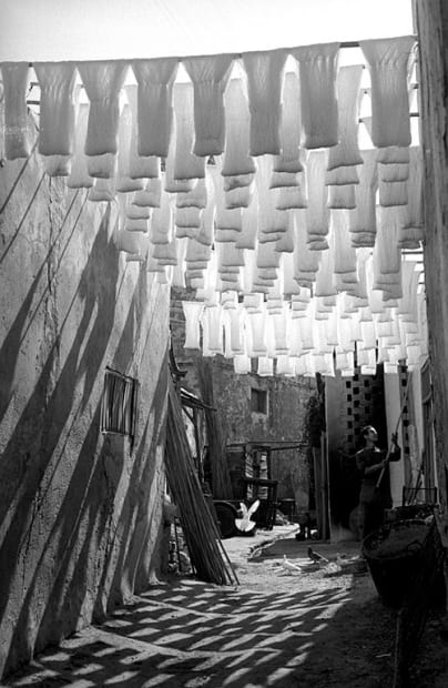 George Rodger, Medina of Tunis. Skeins of cotton hanging to dry in dyers souk, Tunis, Tunisia, 1958.