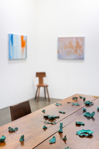 Installation view with works by Sandra Bushby & Cindy Huang. Sumer, Booth H2, Melbourne Art Fair. Photo: Phoebe Powell Normandy farmhouse kitchen table (circa 1850) courtesy of Miguel Meirelles Antiques; Alpine chairs from Laker Studio.