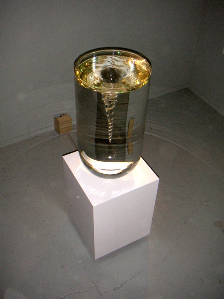 Boost in the Shell - The Pursued: exhibition view at De Bond, Bruges, 2005. Work: Petroc Sesti, Fluid Icon, 2005, plinth, turbine, glass, fluid, 182 x 50 x 50 cm Courtesy of Aeroplastics contemporary, Brussels