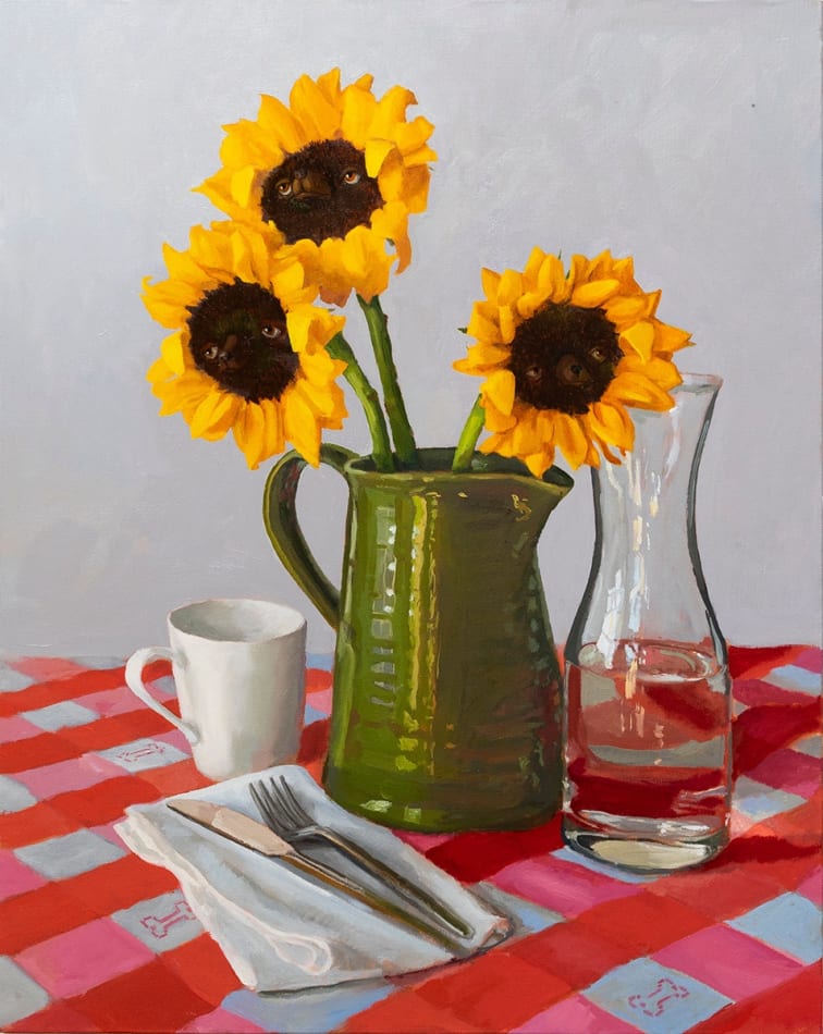 Painting of three sunflowers in a green pitcher on a checkered red and white table clothe. The center of the sunflowers have dog faces in them.
