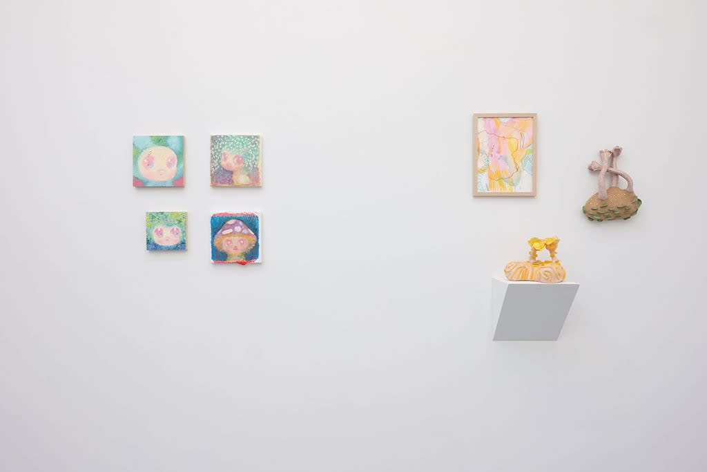 white gallery wall with small assorted artworks