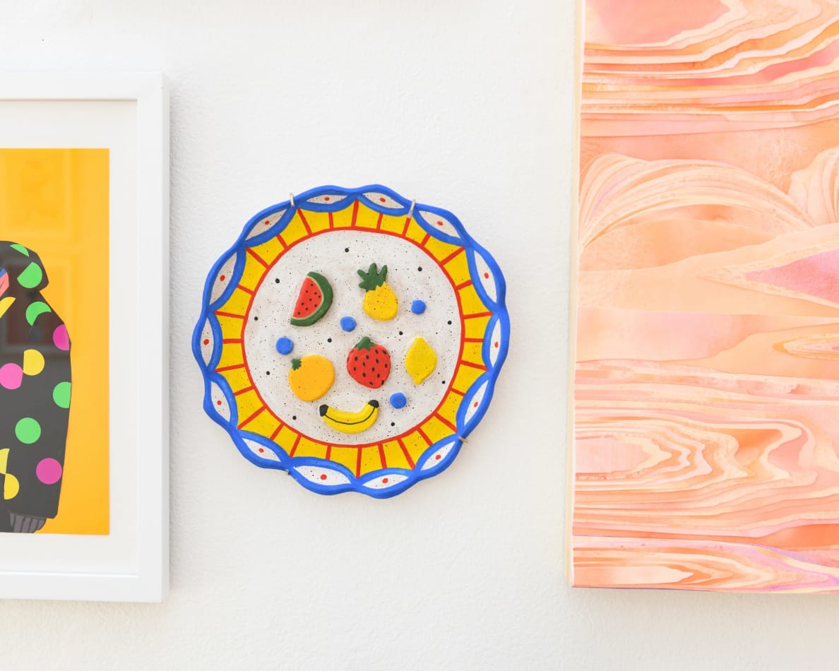 Jackie Brown's sculpture with of a plate with fruit hanging at the gallery