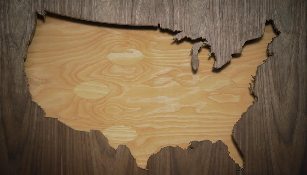 Wooden silhouette of the United States surrounded by darker wood