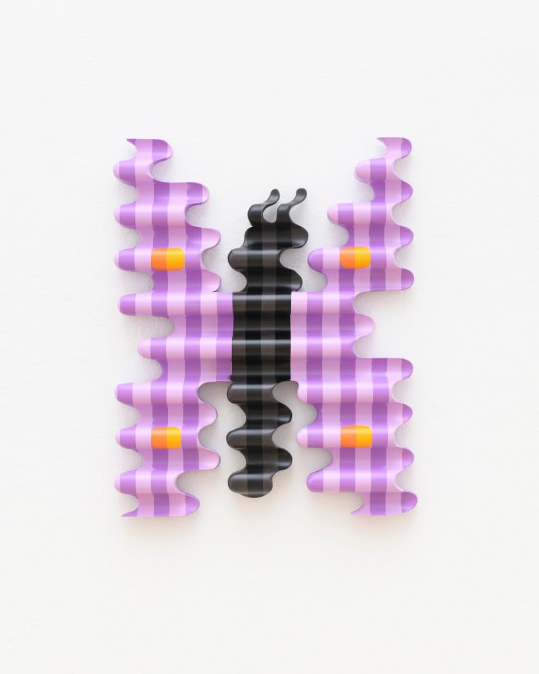 wooden sculpture of a purple by butterfly hanging on a wall by casey gray