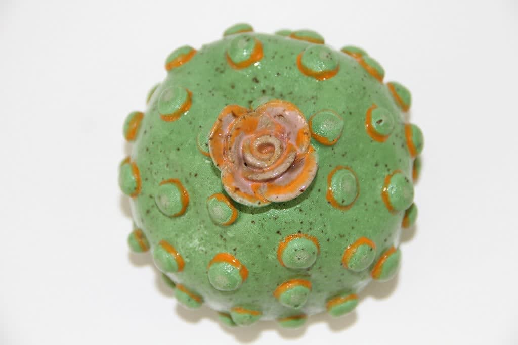 Jen Dwyer sculpture - round green plant with pink flower on top