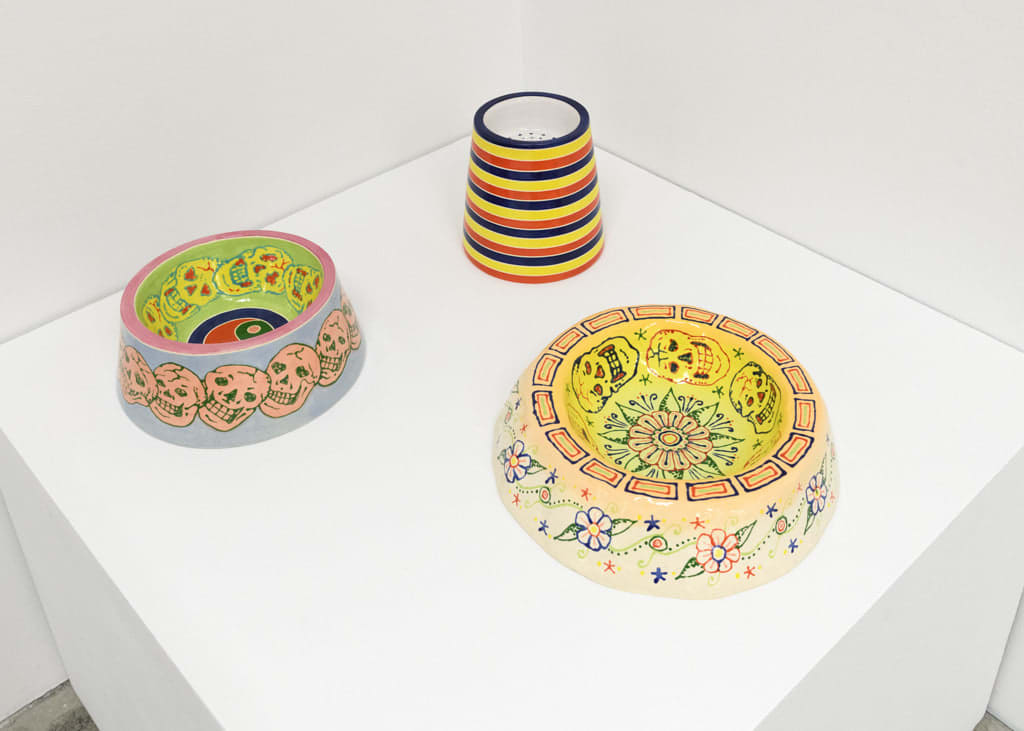 installation view of artist AP Shrewsbury's ceramic dog bowls on a pedestal, installed at Hashimoto Contemporary San Francisco