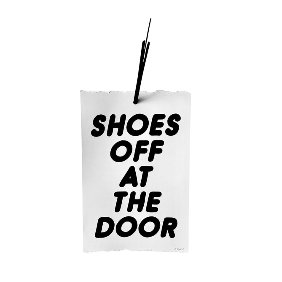 Banner sculpture with a large black arrow and text that reads: 