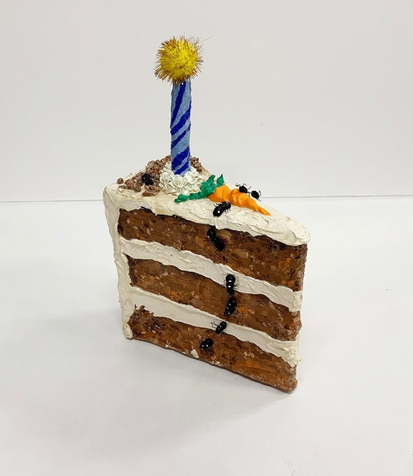 Nic Dyer mixed media sculpture of carrot cake slice blue candle, trail of ants going down slice