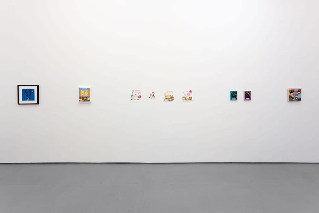 white gallery wall with small assorted artworks