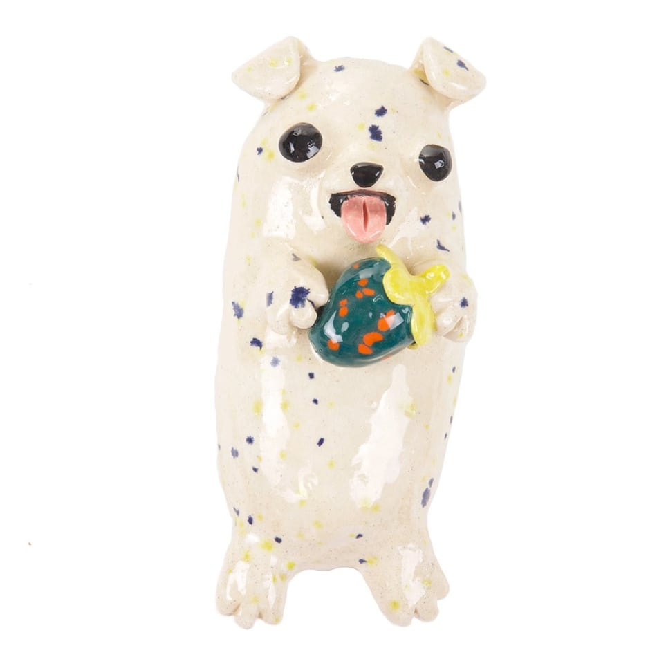 Katie Kimmel's ceramic sculpture of a dog holding a strawberry
