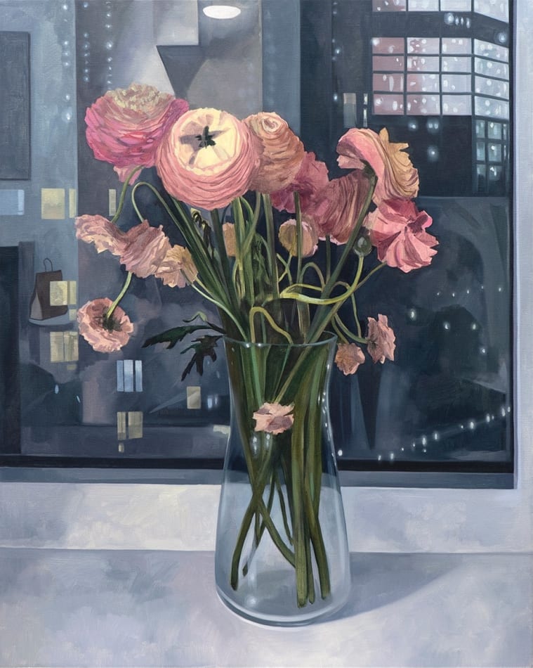 pink flowers in a vase sitting on a cityscape windowsill