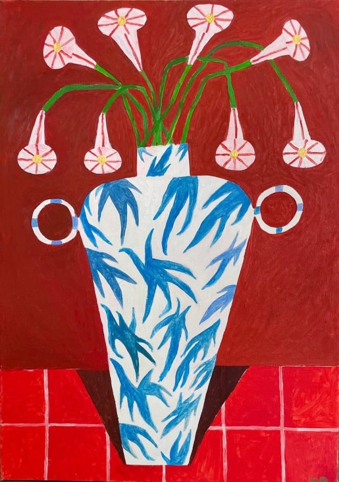 pink flowers in a blue patterned vase over a bright red background