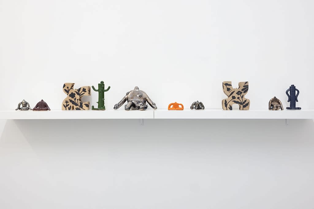 white shelf with assorted small figure statues by Jocelyn Tsaih