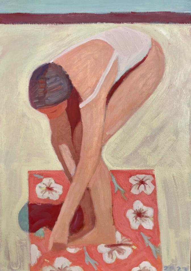 woman bending over on a floral beach towel