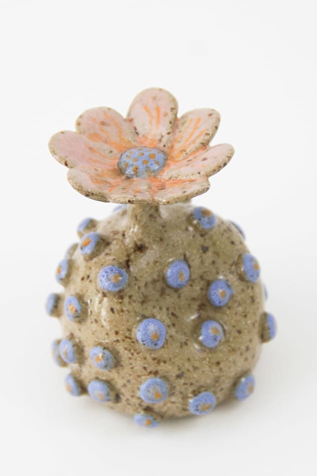 Jen Dwyer sculpture - round tan plant with blue dots all over and pink flower on top