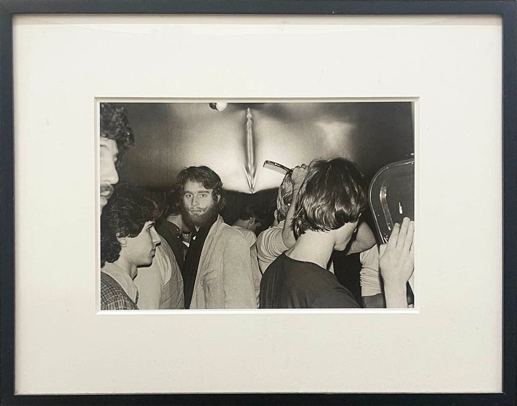 Black and white photo of men inside a bathroom