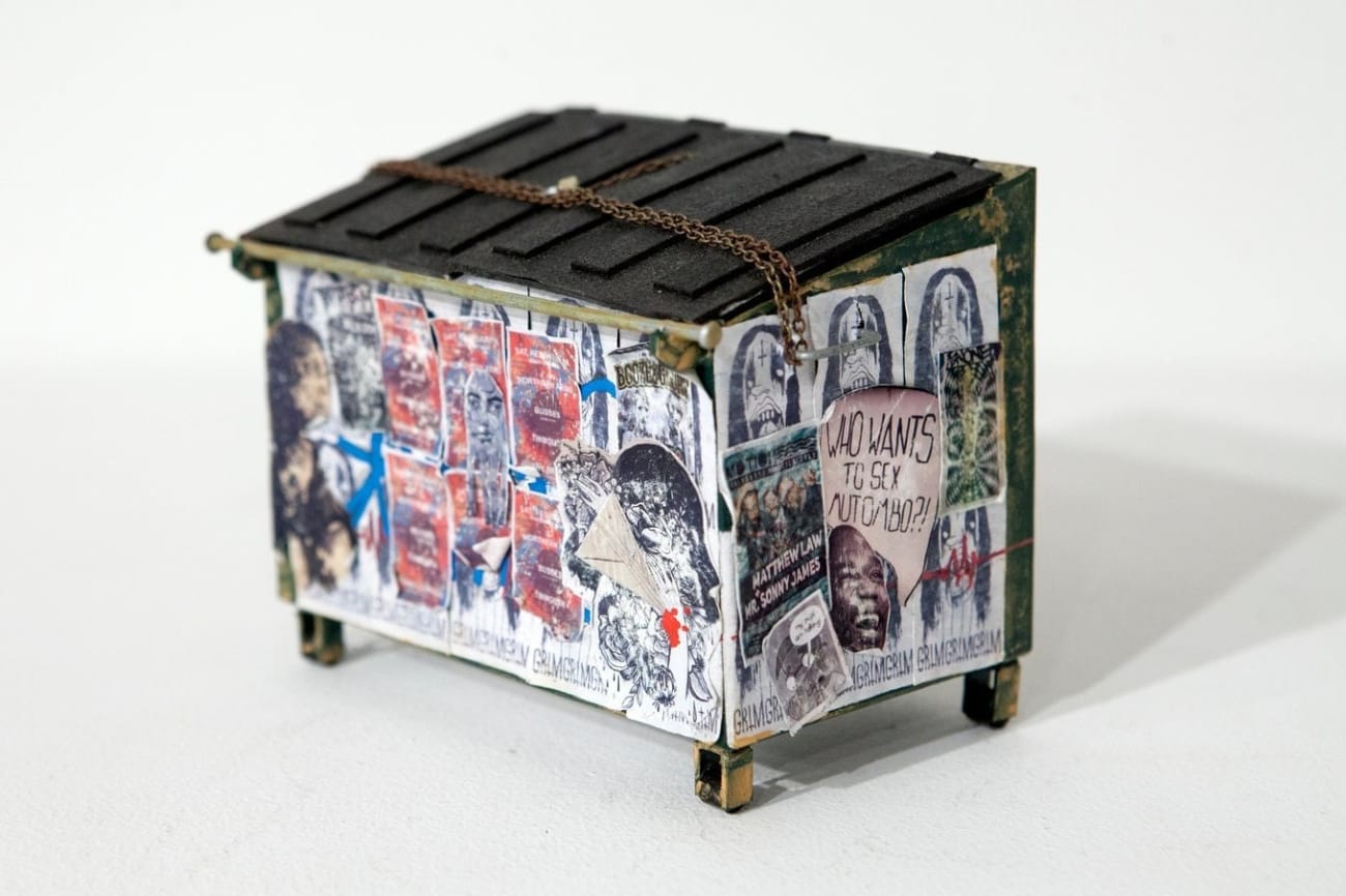 Drew Leshko miniature blue dumpster covered in wheatpaste