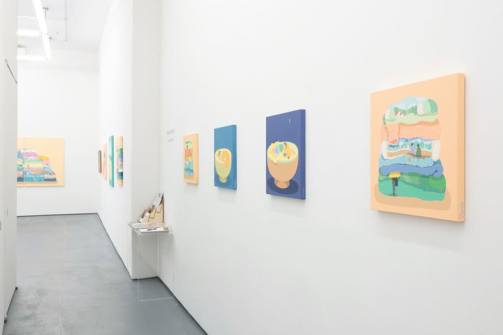 White gallery wall with various paintings by Danym Kwon