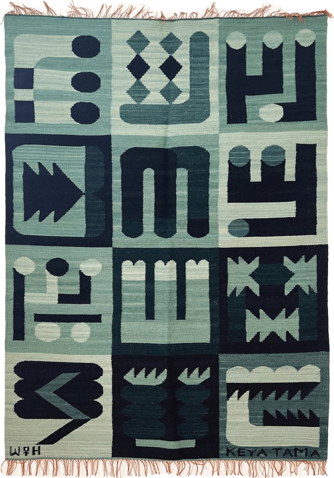 green knit rug decorated with 12 abstract symbols in a grid