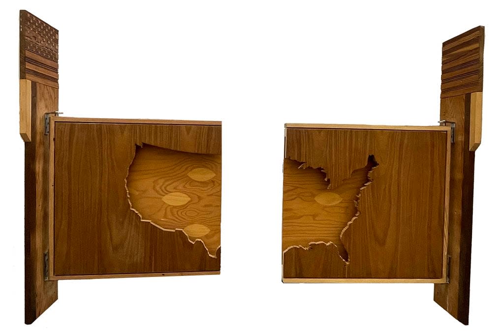 Wooden silhouette of the United States surrounded by darker wood cut in half and hung as saloon doors