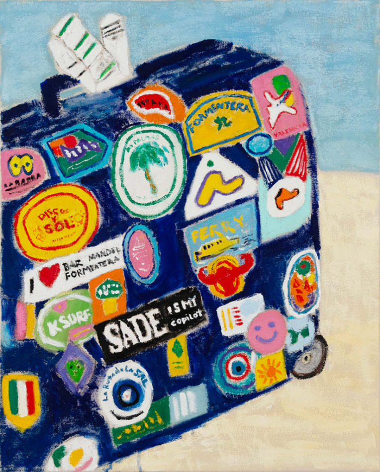 dark blue suitcase covered in travel stickers