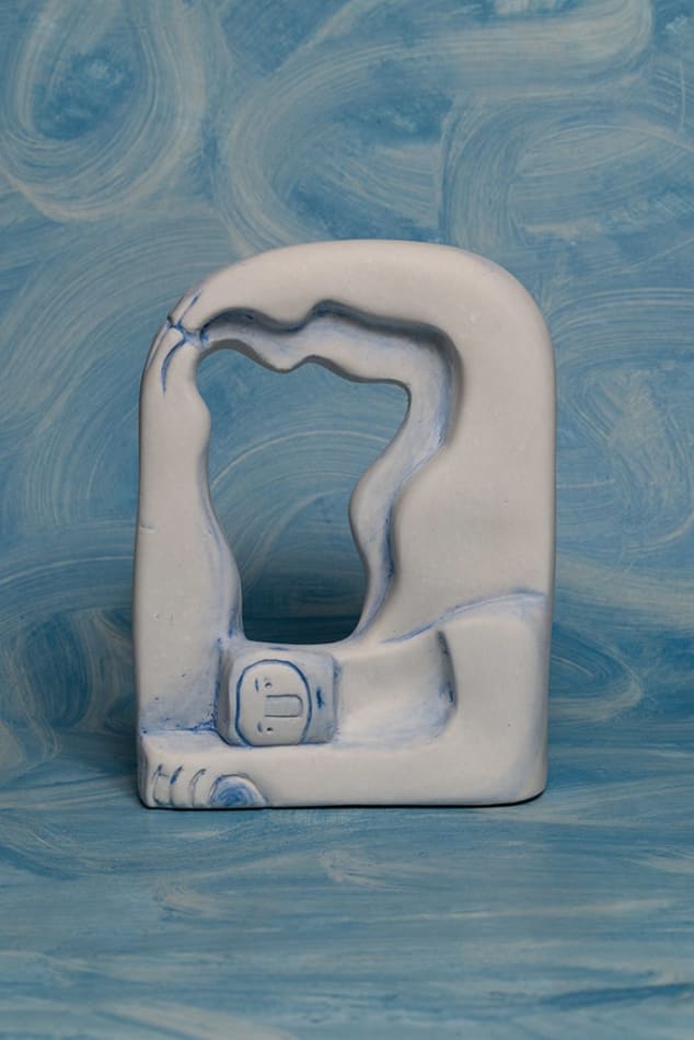 sculpture of a man laying on his stomach with his lehgs and arm in the air