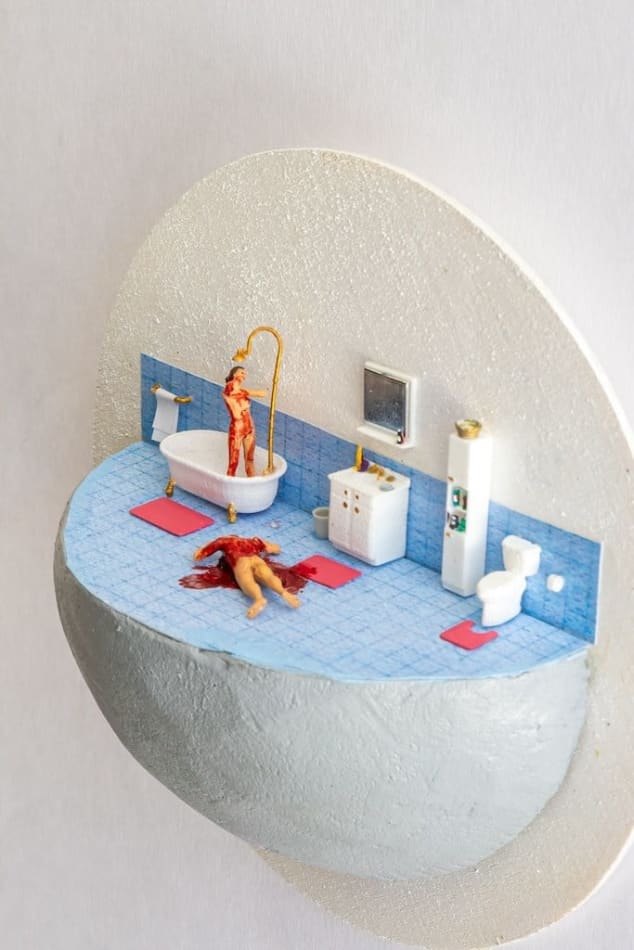 miniature diorama by Abigail Goldman a bloody woman washing herself in the shower next to a body bleeding out on the floor