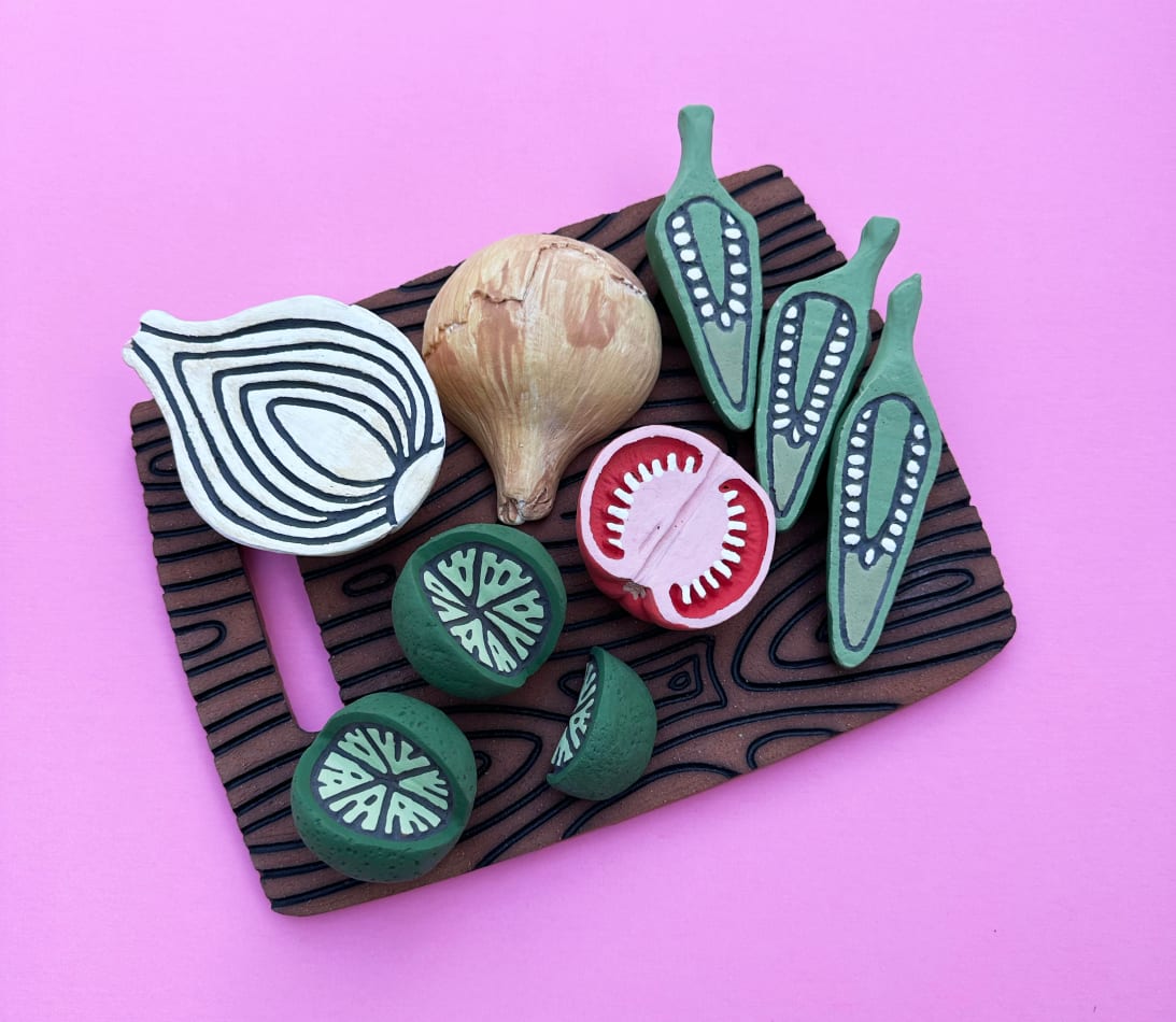 Christina Margarita Erives - ceramic stylized cutting board with sliced limes, tomato, peppers and onion