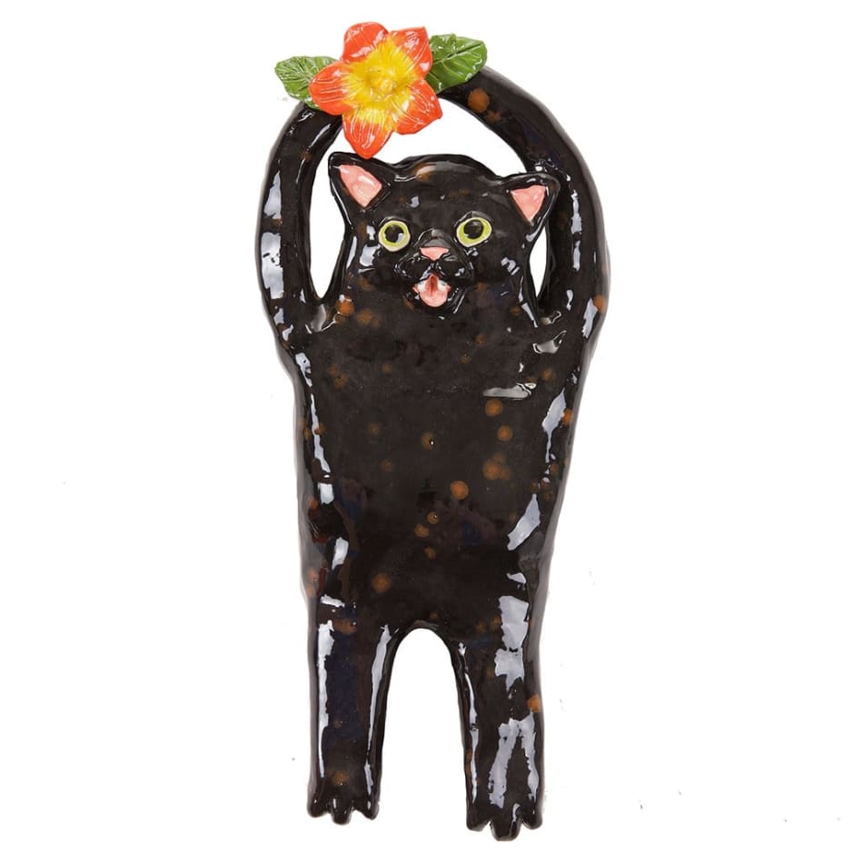 Katie Kimmel's ceramic sculpture of a black cat holding a flower