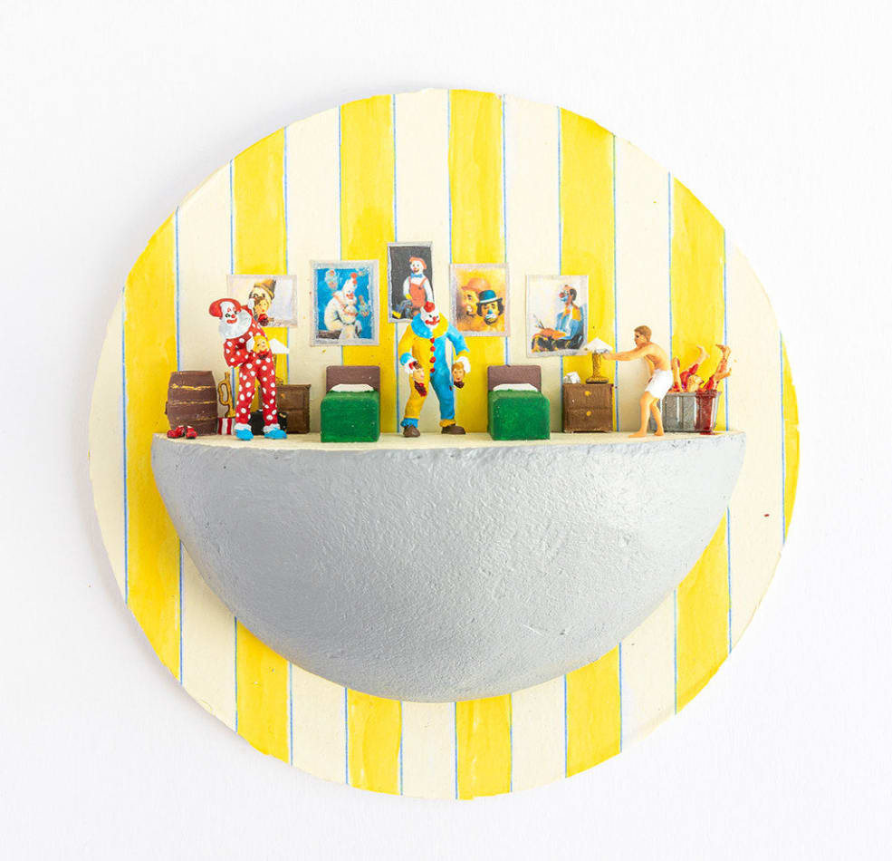 miniature diorama by Abigail Goldman of two clowns holding dismembered body parts and another victim off to the side
