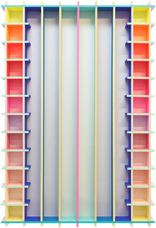 brightly colored painted wooden sculpture with long vertical lines in the center