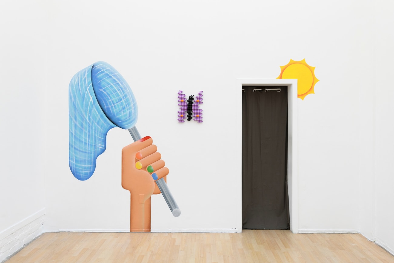 wooden sculpture of a purple by butterfly hanging on a wall with a mural by casey gray