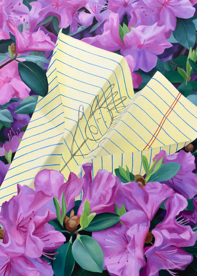 a paper airplane made of yellow lined paper with a doodle on it resting in a bed of purple flowers