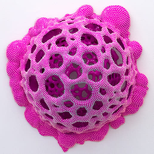 Sculpture by Dan Lam of a drippy sphere covered in tiny spikes with small holes in broken out of it